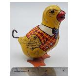 Vintage tin lithograph wind-up waddling chick toy