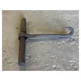 Vintage hand-forged iron hay bale hook with a