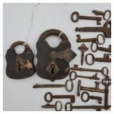 Antique metal padlocks and assorted keys