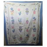 Blue Trimmed Quilt w/Floral Arrangements