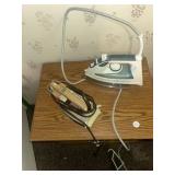 Two irons and one large and one small ironing