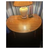 Round double drop leaf table and two wooden chairs
