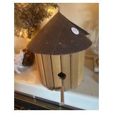 Round wooden birdhouse and a piggy bank full of