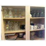 Cabinet full of glasses, cups, corn on cob dishes