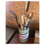 Miller highlife trashcan with umbrellas and a