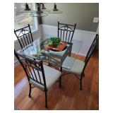 Glass, top dining table and four iron base chairs