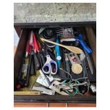 Drawer, full of kitchen gadgets knives