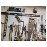 Several tools on pegboard and on top of workbench