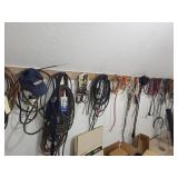 Lots of items hanging on wall wire fan belt,