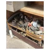 3 shelves full:  pipe, pulleys,