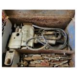 Large old drill in metal box