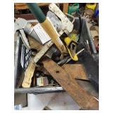 Plastic milk crate, full of lawnmower, blades,