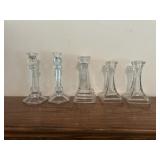 Five glass candle holders 7 to 8 inches tall