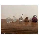 Five early inkwells, purple, cone, red, clear