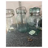 3 'Lightning' Fruit jars with glass lids.