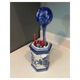 Blue and white vase with pens and blue flower