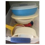 Large plastic container, full of Tupperware and