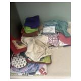 Lots of kitchen, dish towels, and potholders