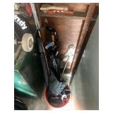 Bucket of various golf, clubs, golf bag, and