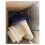 Box of Tupperware, plastic lids, and pan