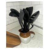 Crock picture with plastic serving utensils and a