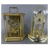 2 gold-tone rotating pendulum anniversary clocks,