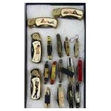 17 vintage pocket knives in glass display case
