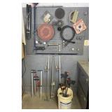 Group of bar clamps and contents of pegboard,