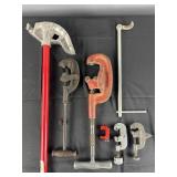 Group of pipe cutters, bender and wrench