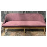Mid century modern couch with plum upholstery,