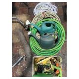 Group of hoses, sprinklers, watering cans and