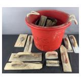 Group of concrete trowels, brushes and tub