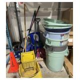 Group of trash cans, mop bucket, brooms and more