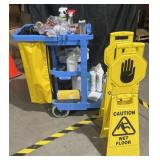 Cleaning cart with waste bin and wet floor signs,