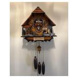 Chalet-style Black Forest cuckoo clock features a