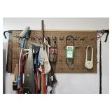 Contents of pegboard: level, hand saws, crow bar,