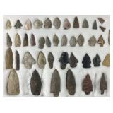 Collection of arrowheads and points in case,