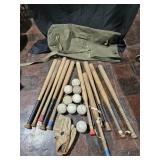 Ball bats, softballs, glove and army bag. 10