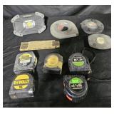 Assorted measuring tapes and Husky battery