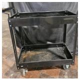 Black, metal rolling cart. 29'x15'. Rolls as it