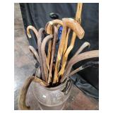 Wooden walking canes and rustic milk can