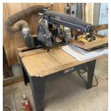 Vintage DeWalt radial arm saw mounted on a wooden