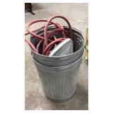 TWO METAL TRASH CANS AND A HOSE