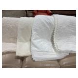 Four White Bed Coverings With Quilted Designs