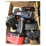 Group of cordless drills and extra batteries and