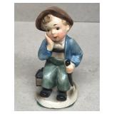 Tired boy figurine