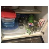 Candy jars and Tupperware contents of cabinet