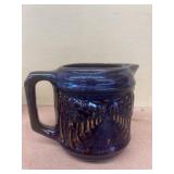 Stoneware cup with tree design does have chip on