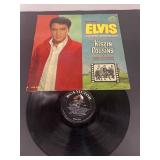 Elvis Presley kissing Cousin's record album