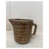 Brown pottery measuring glass